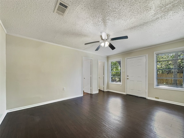 empty room with dark hardwood / wood-style flooring, ceiling fan, a textured ceiling, and a wealth of natural light