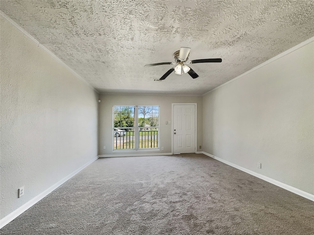 carpeted empty room featuring ceiling fan and a textured ceiling