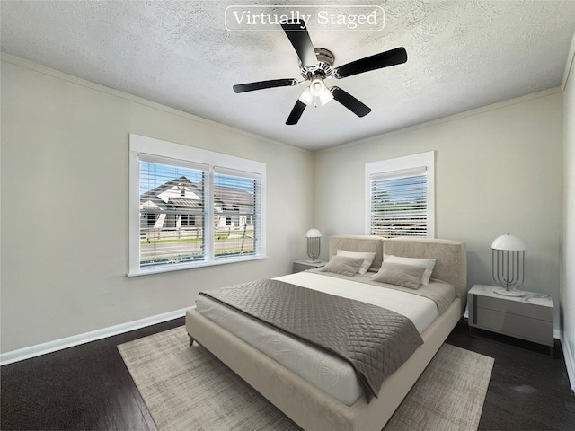 bedroom featuring a textured ceiling, ceiling fan, dark wood-type flooring, and crown molding