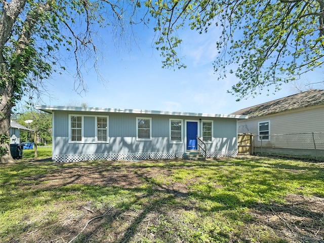 rear view of house featuring a yard