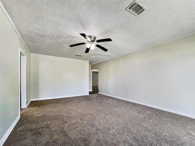 carpeted spare room featuring ceiling fan and a textured ceiling