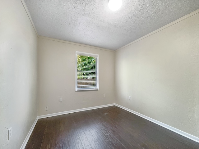 unfurnished room with dark hardwood / wood-style flooring, ornamental molding, and a textured ceiling