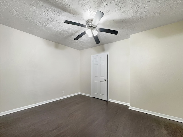 spare room featuring a textured ceiling, ceiling fan, and dark wood-type flooring