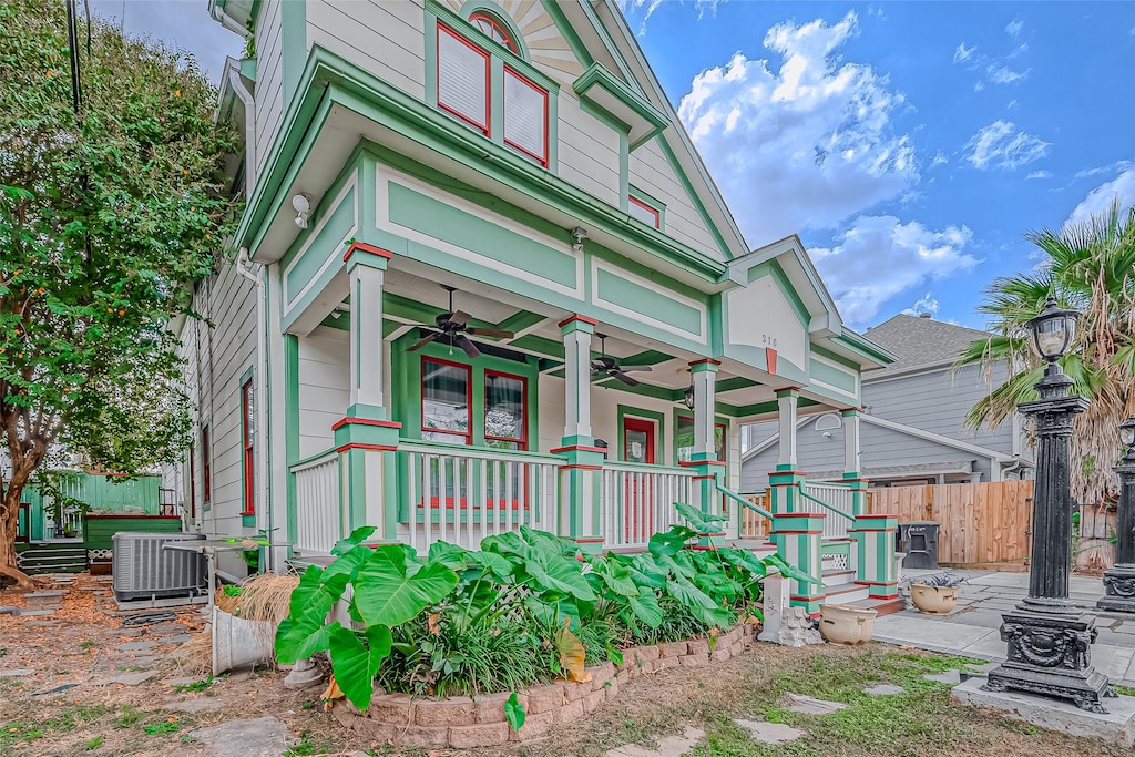 view of front of property featuring cooling unit, covered porch, and ceiling fan