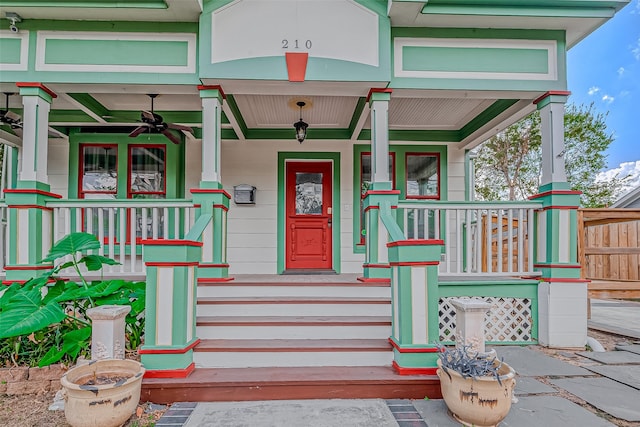 view of exterior entry featuring covered porch and ceiling fan