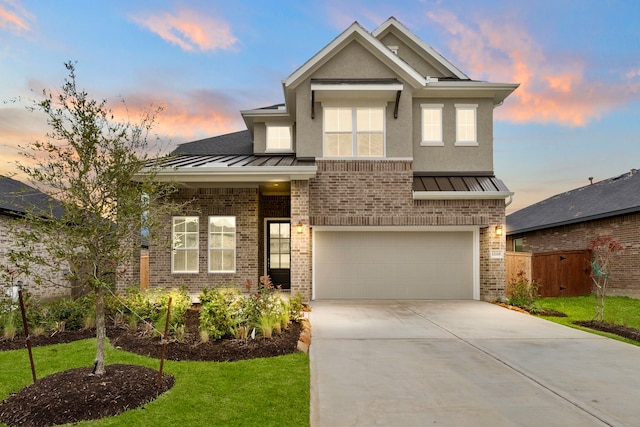 view of front of house with a garage and a lawn