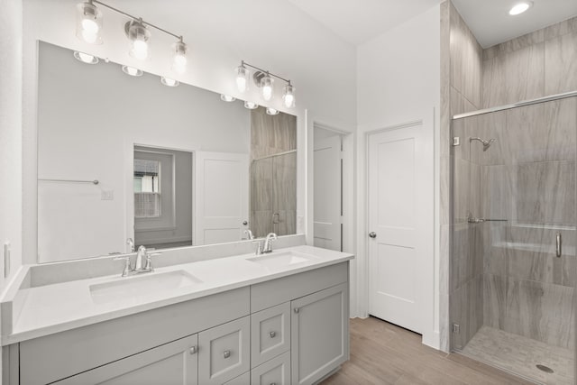 bathroom with an enclosed shower, vanity, and hardwood / wood-style floors