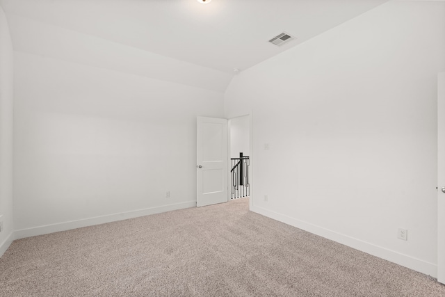 spare room with lofted ceiling and carpet