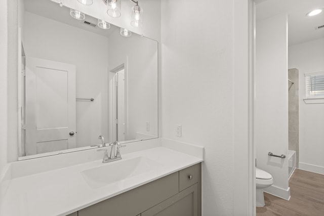 full bathroom with vanity, shower / bathing tub combination, hardwood / wood-style flooring, and toilet