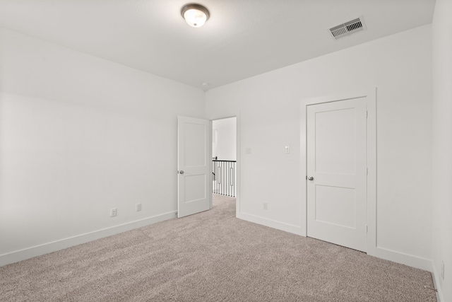 unfurnished bedroom with light carpet