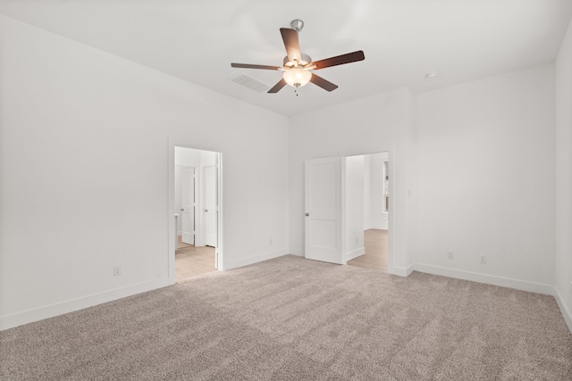 carpeted spare room featuring ceiling fan