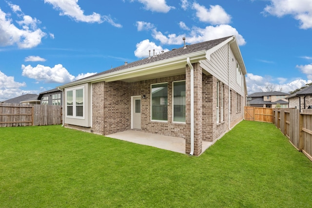 rear view of property with a patio and a lawn