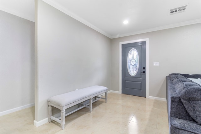 tiled entrance foyer featuring crown molding