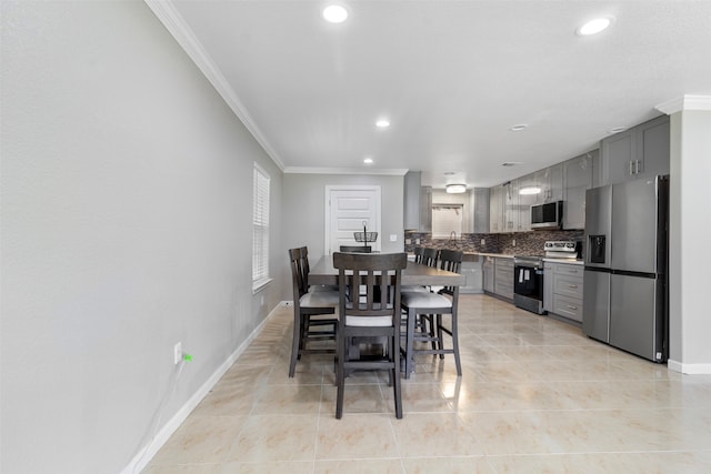 tiled dining room featuring crown molding