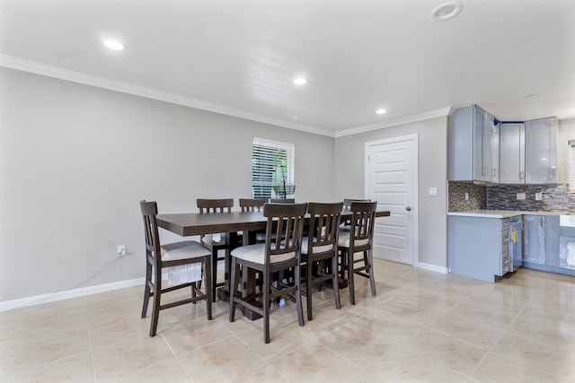 tiled dining area featuring crown molding