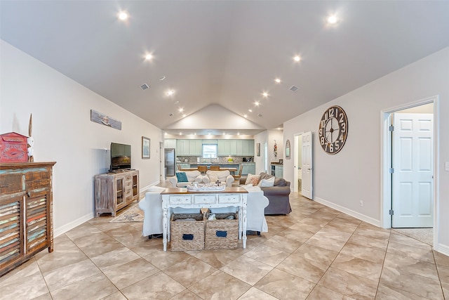 living room with light tile floors and vaulted ceiling