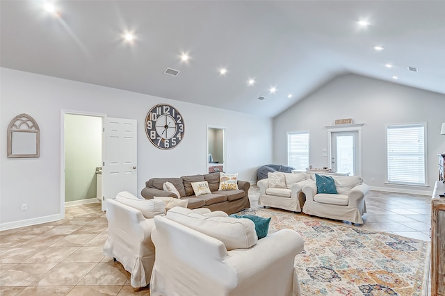 living room with light tile flooring and vaulted ceiling