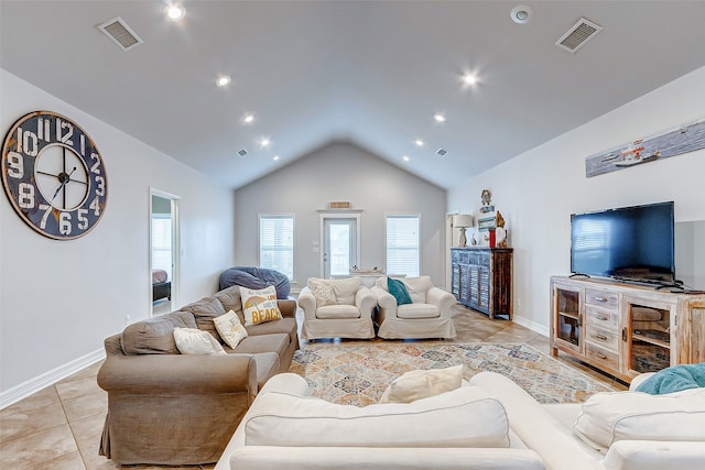 living room featuring vaulted ceiling and light tile floors