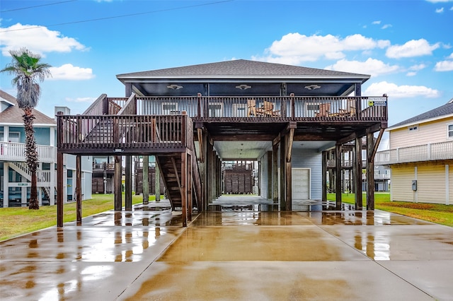 rear view of house featuring a yard and a deck