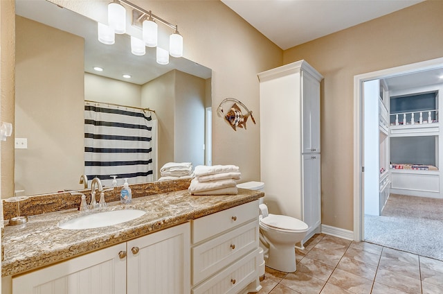 bathroom featuring vanity, tile floors, and toilet