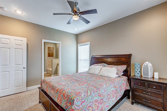 carpeted bedroom featuring ceiling fan and ensuite bathroom