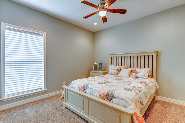 bedroom with light colored carpet and ceiling fan