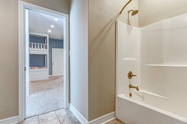 bathroom with tile flooring and washtub / shower combination