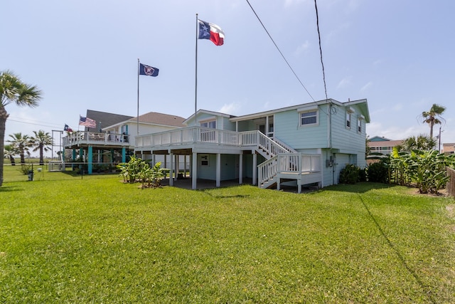 back of house with a wooden deck, stairs, a yard, and fence