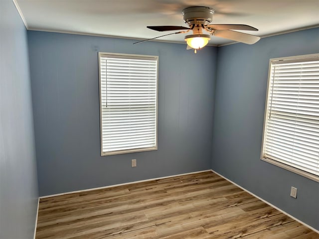 unfurnished room featuring wood finished floors, ceiling fan, and ornamental molding