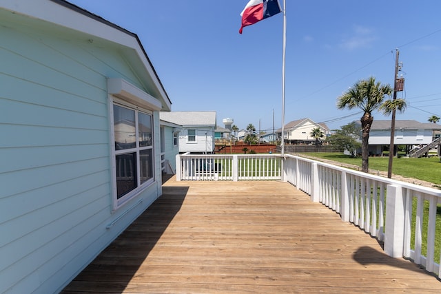 deck featuring a yard, fence, and a residential view