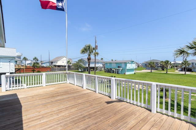 deck featuring a residential view and a lawn