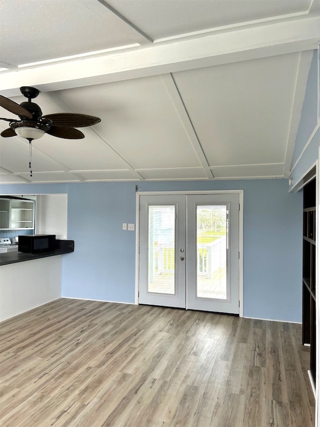 unfurnished living room featuring french doors, ceiling fan, and wood finished floors