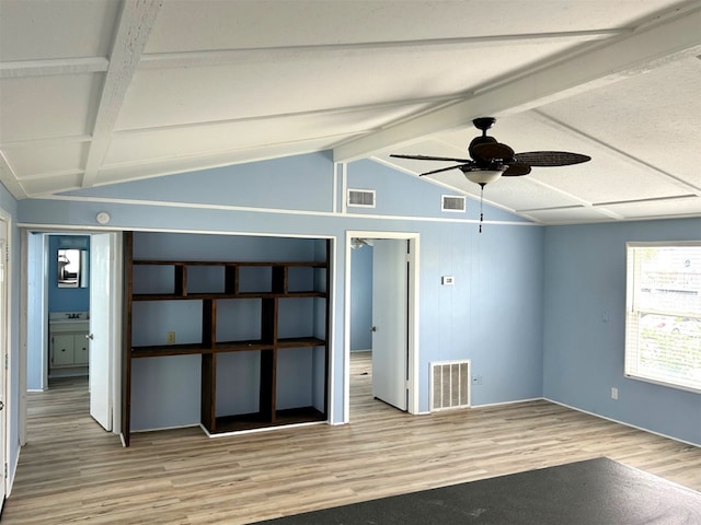 interior space featuring visible vents, vaulted ceiling with beams, and wood finished floors