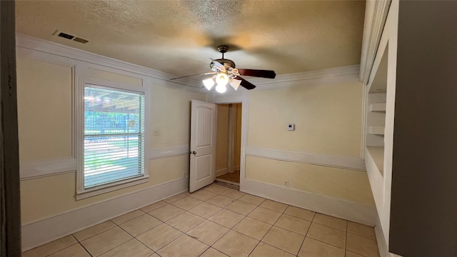 tiled spare room featuring ceiling fan and a textured ceiling