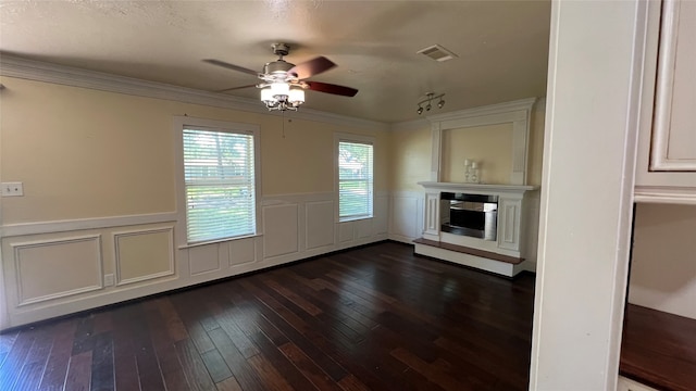 unfurnished living room with dark hardwood / wood-style flooring, ceiling fan, and crown molding