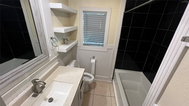 full bathroom featuring tile flooring, tiled shower / bath combo, large vanity, and toilet