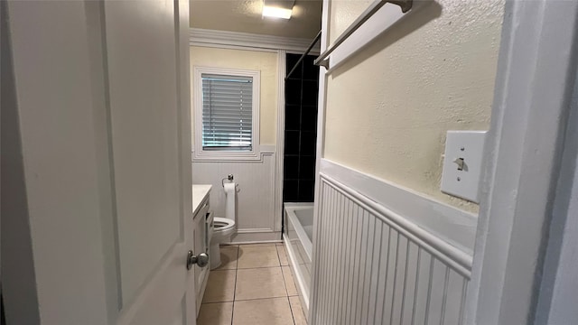 full bathroom with tile flooring, bathtub / shower combination, ornamental molding, toilet, and vanity