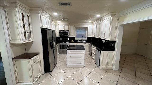 kitchen featuring sink, white cabinets, tasteful backsplash, and appliances with stainless steel finishes