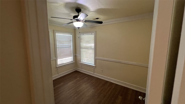 spare room featuring ceiling fan, dark hardwood / wood-style flooring, and crown molding