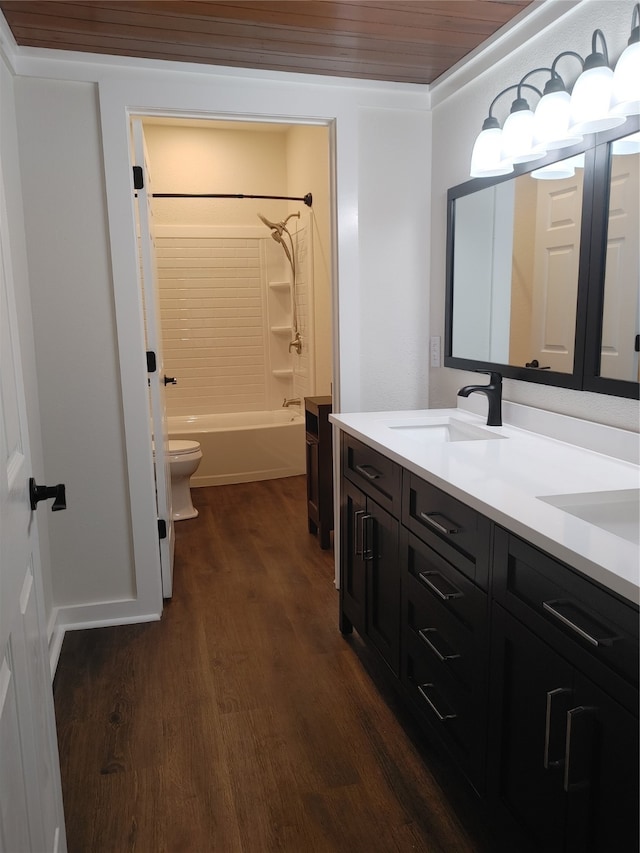 full bathroom with vanity with extensive cabinet space, wood-type flooring, wooden ceiling, bathtub / shower combination, and toilet