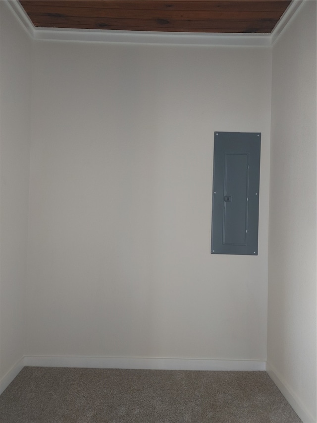 carpeted spare room featuring wooden ceiling