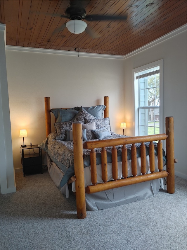 carpeted bedroom with wooden ceiling, ceiling fan, and crown molding