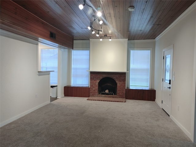 unfurnished living room with carpet flooring, crown molding, track lighting, and wooden ceiling