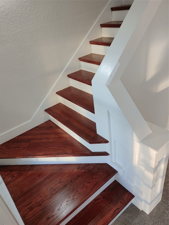 stairs featuring wood-type flooring