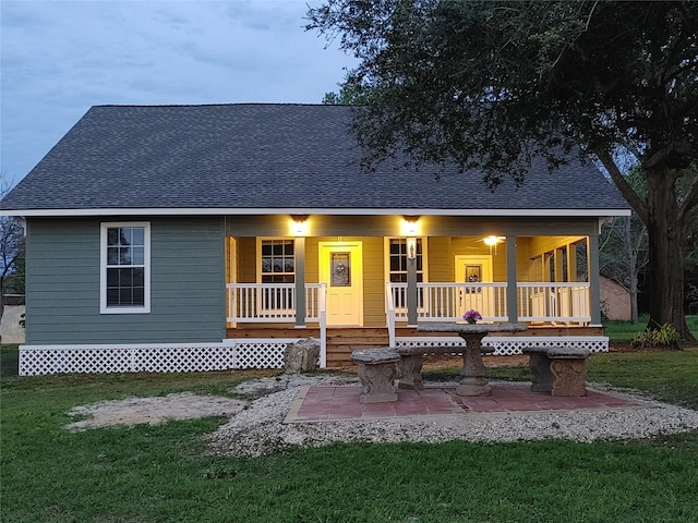 view of front of property with a yard and covered porch