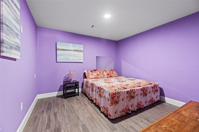 bedroom with hardwood / wood-style flooring