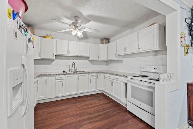 kitchen with backsplash, white appliances, ceiling fan, dark wood-type flooring, and sink