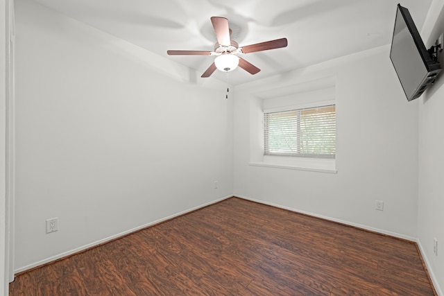 empty room with ceiling fan and dark wood-type flooring