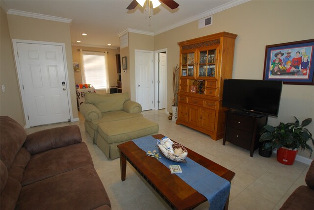 tiled living room with ceiling fan and crown molding