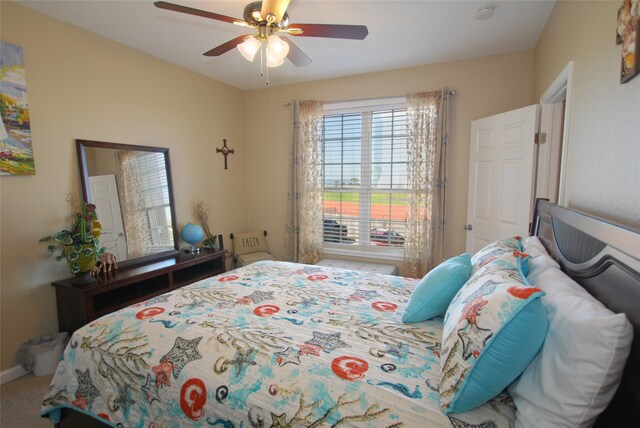 bedroom featuring ceiling fan and carpet floors